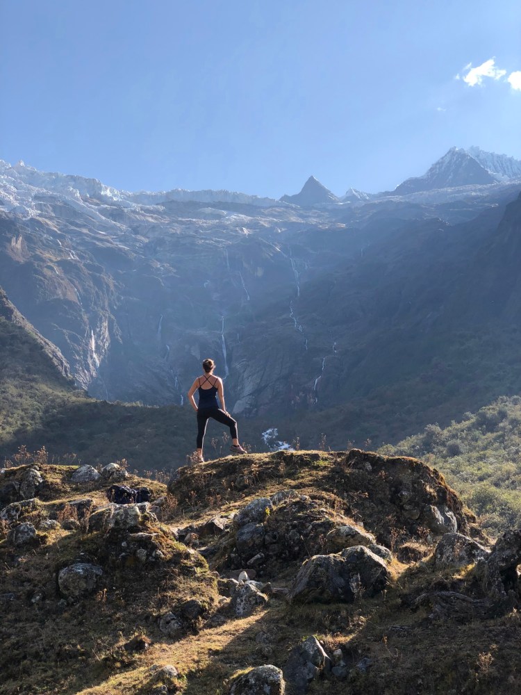 a man standing in front of a mountain