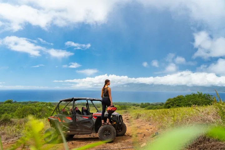 a man riding a bike down a dirt road